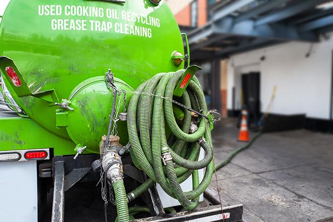 a grease trap pumping truck at a restaurant in Hamtramck